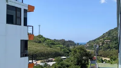 a view of a mountain from a building at Charming Beachside Studio in Rawai Beach