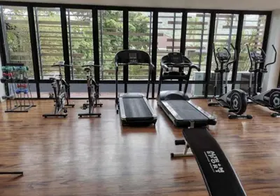 a gym with several treadmills and elliptical machines at Charming Beachside Studio in Rawai Beach