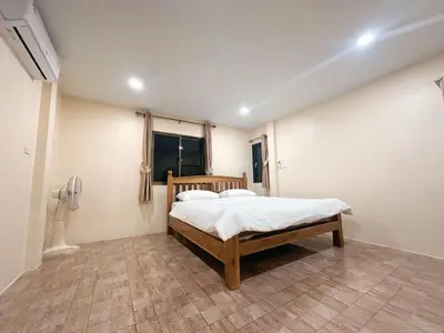 a bedroom with a bed in a room at Ganchanid House in Ko Yao Noi