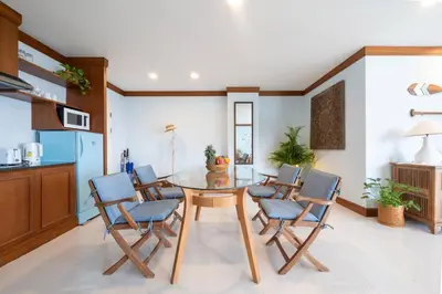 a kitchen and dining room with a table and chairs at Waterfront High Tide Suite - Ocean View in Karon Beach