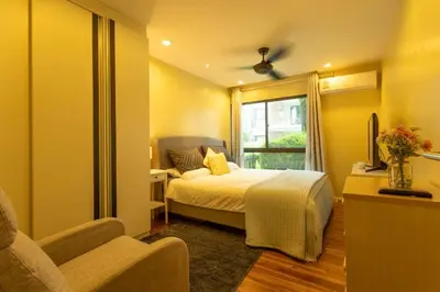 a bedroom with a bed and a chair and a window at Neatest Apartment 50m To Main Street And Beach C149 in Rawai Beach
