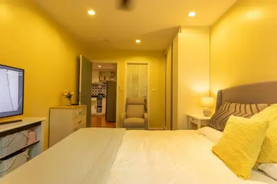 a bedroom with a large bed and a television at Neatest Apartment 50m To Main Street And Beach C149 in Rawai Beach