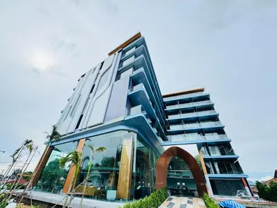 a tall building with an arch in front of it at The Blue Mavi Hotel in Chalong