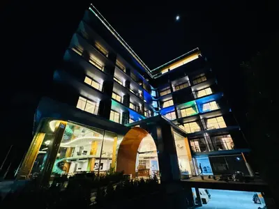 a large building with lit up windows at night at The Blue Mavi Hotel in Chalong