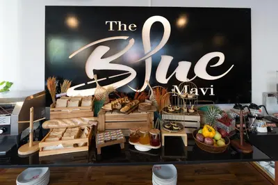 a sign for the bite mayaan with a bunch of food at The Blue Mavi Hotel in Chalong