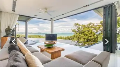 a living room with a large couch and a table at Ocean Heart 5BDR Seaview LUX villa in Ban Bang La