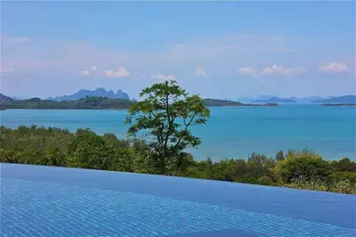 a large swimming pool with a view of a lake at Ocean Heart 5BDR Seaview LUX villa in Ban Bang La