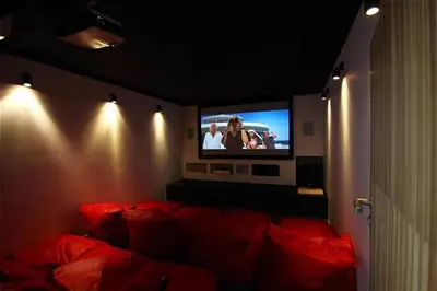 a living room with a red couch and a tv at Ocean Heart 5BDR Seaview LUX villa in Ban Bang La