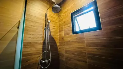 a bathroom with a shower with a window at Rawaii Vip Villa 2D101 in Phuket Town