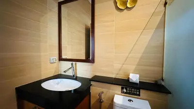 a bathroom with a sink and a mirror at Rawaii Vip Villa 2D101 in Phuket Town
