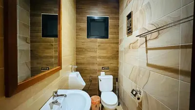 a bathroom with a toilet and a sink and a mirror at Rawaii Vip Villa 2D101 in Phuket Town