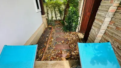 two blue chairs sitting in front of a house at Rawaii Vip Villa 2D101 in Phuket Town