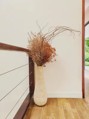 a vase with branches in it sitting on a floor at modern hill villa \u5c71\u95f4\u89c2\u6d77\u79c1\u4eba\u522b\u5885 in Patong Beach