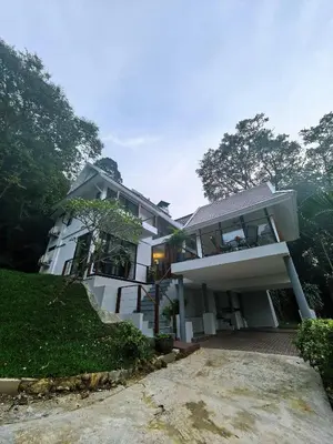 a large white house with trees in the background at modern hill villa \u5c71\u95f4\u89c2\u6d77\u79c1\u4eba\u522b\u5885 in Patong Beach