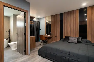 a bedroom with a bed and a bathroom with a sink at Three Double U - Kalim Sea View in Patong Beach