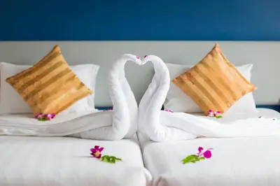 two swans making a heart on a bed at ON Hotel Phuket - SHA in Karon Beach
