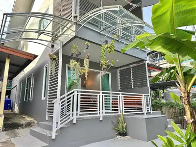 a house with a white railing and a balcony at Areeya Khao Khad Aoyon Beach in Ban Ao Makham