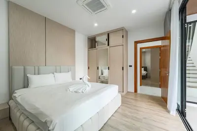 a bedroom with a large white bed with a swan on it at Peaceful Paradise in Saiyuan Villa V147 in Rawai Beach