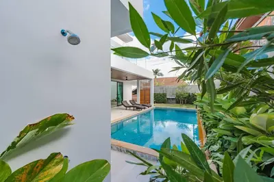 a villa with a swimming pool and a house at Peaceful Paradise in Saiyuan Villa V147 in Rawai Beach
