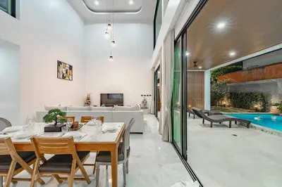a dining room with a table and a swimming pool at Peaceful Paradise in Saiyuan Villa V147 in Rawai Beach