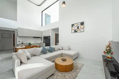 a living room with a white couch and a table at Peaceful Paradise in Saiyuan Villa V147 in Rawai Beach