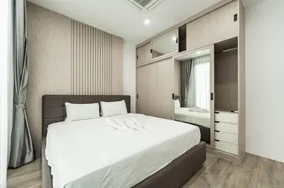 a bedroom with a large bed and a mirror at Peaceful Paradise in Saiyuan Villa V147 in Rawai Beach