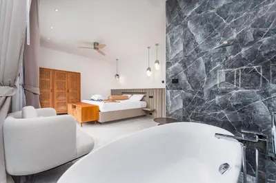 a bathroom with a white sink and a bedroom at VILLA Satori 4BR by Tropiclook in Rawai Beach