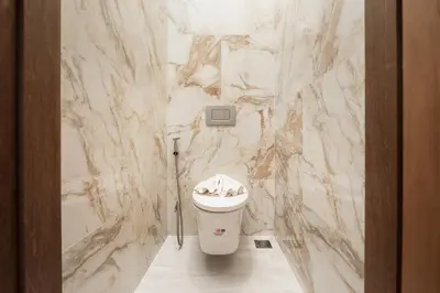 a bathroom with a marble wall with a toilet at VILLA Satori 4BR by Tropiclook in Rawai Beach