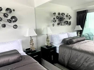 a bedroom with two beds and two lamps and a mirror at Kata Ocean View 1 bedroom 50 m2 in Kata Beach