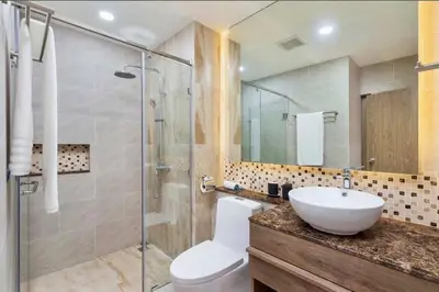 a bathroom with a sink and a glass shower at One bedroom apartment Calypso Garden in Phuket Town