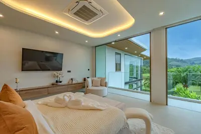 a bedroom with a bed and a large window at Luxury Golfside Villa near Patong - Villa Priva in Kathu