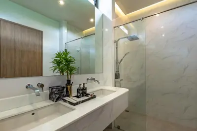 a bathroom with a sink and a shower at Luxury Golfside Villa near Patong - Villa Priva in Kathu