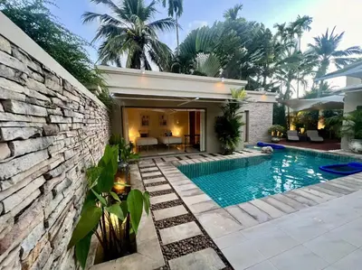 a swimming pool in front of a house at Pool villa at The Residence near BangTao beach in Bang Tao Beach