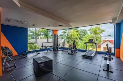 a gym with cardio equipment and a large window at Brand New Luxury 3BR with Private Hammam in Chalong