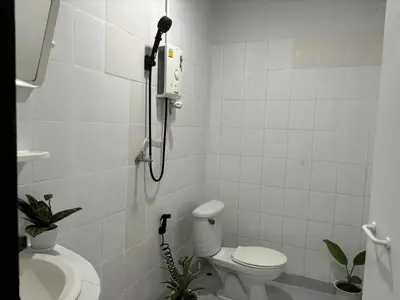 a bathroom with a shower and a toilet and a sink at White House in Phi Phi Don