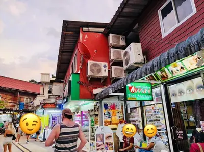 a man standing in front of a store with pumpkins on the facade at White House in Phi Phi Don