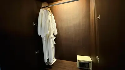 a robe hanging on a door in a bathroom at Onyx Pool Villa in Phuket Town