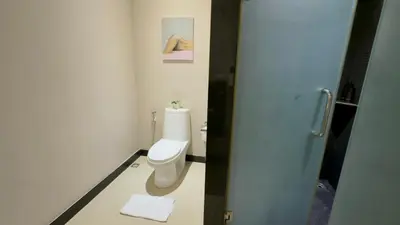 a bathroom with a white toilet in a room at Onyx Pool Villa in Phuket Town