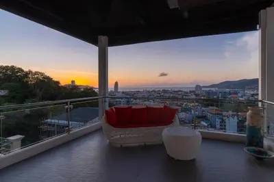 a couch on a balcony with a view of a city at \u542b\u65e9\u9910\u9001\u63a5\u673a Phuket patong 4Bedrooms seaview Pool villa in Patong Beach
