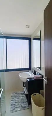 a bathroom with a sink and a mirror and a window at Bangtao Beach 600m Laguna 3BDR 3,5bath with Jacuzzi and BBQ up to 8 guests 5 nights Free taxi in Phuket