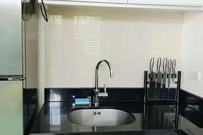 a kitchen with a sink and a black counter top at Bangtao Beach 600m Laguna 3BDR 3,5bath with Jacuzzi and BBQ up to 8 guests 5 nights Free taxi in Phuket