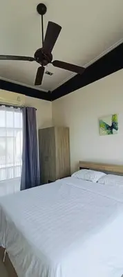 a bedroom with a bed with a ceiling fan at Bangtao Beach 600m Laguna 3BDR 3,5bath with Jacuzzi and BBQ up to 8 guests 5 nights Free taxi in Phuket