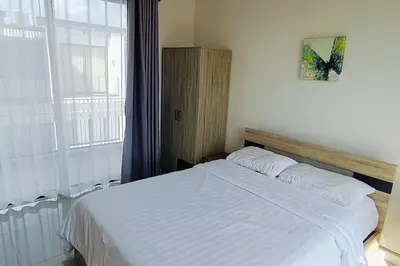 a bedroom with a white bed with a window at Bangtao Beach 600m Laguna 3BDR 3,5bath with Jacuzzi and BBQ up to 8 guests 5 nights Free taxi in Phuket