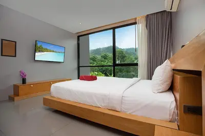 a bedroom with a bed and a large window at Stylish 3-Storey Private Pool Villa, Gentle Breeze, Kamala in Kamala Beach
