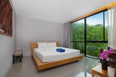 a bedroom with a bed and a large window at Stylish 3-Storey Private Pool Villa, Gentle Breeze, Kamala in Kamala Beach