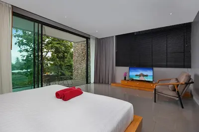 a bedroom with a bed with a red pillow on it at Stylish 3-Storey Private Pool Villa, Gentle Breeze, Kamala in Kamala Beach