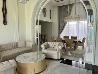 a living room with a couch and a table at Gold Chariot 4BR villa with pool in Phuket