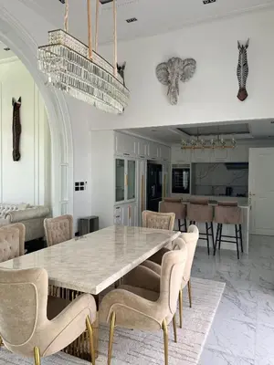 a dining room with a large table and chairs at Gold Chariot 4BR villa with pool in Phuket