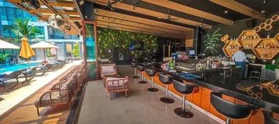 a bar in a restaurant with a swimming pool at Private apartments near Kata beach in Kata Beach