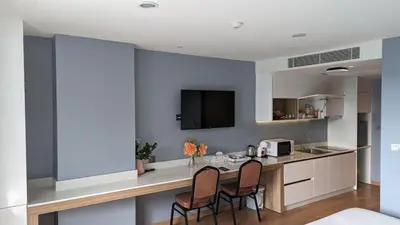a kitchen with a counter and chairs in a room at Private apartments near Kata beach in Kata Beach